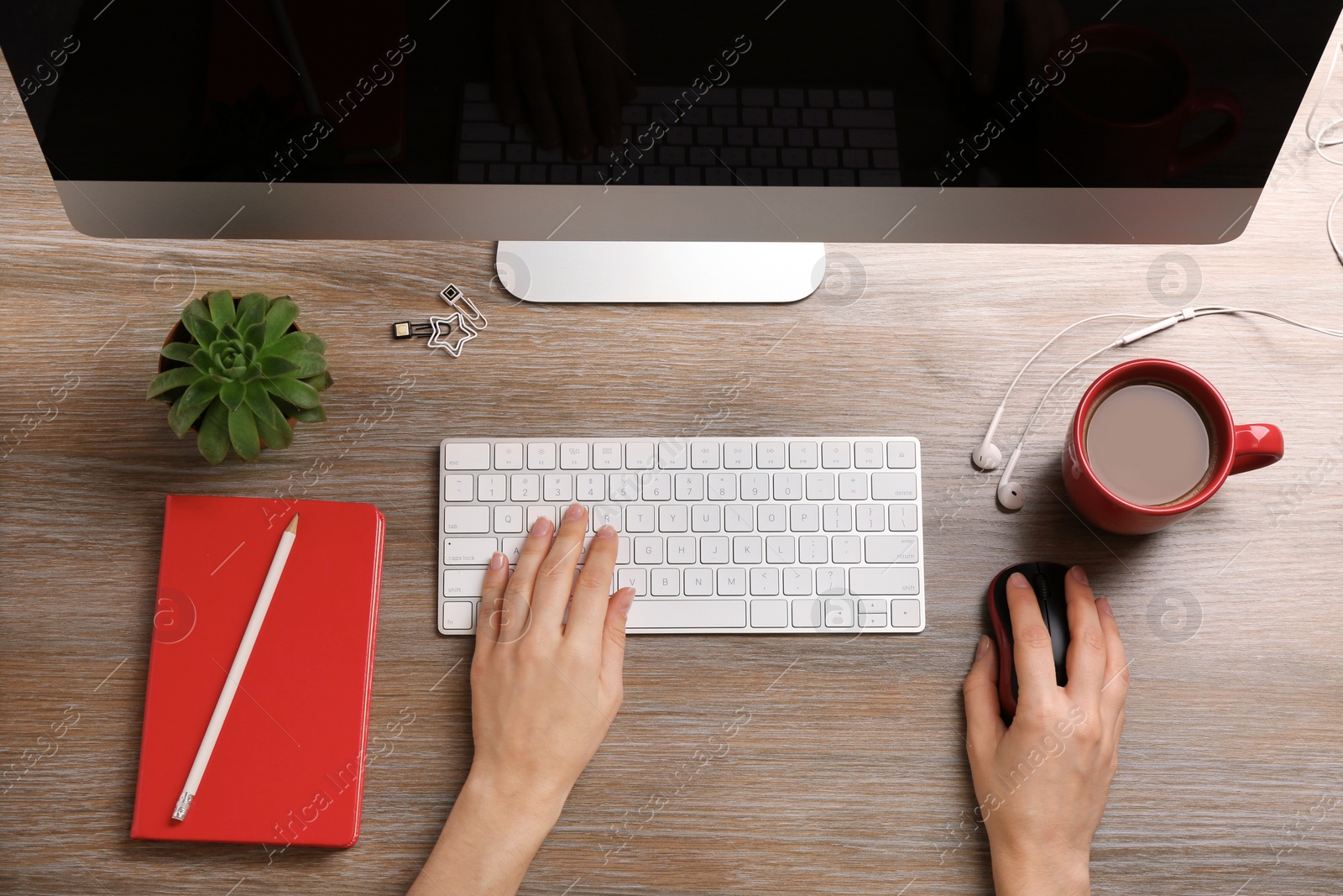 Photo of Woman using computer mouse and keyboard at office table, top view