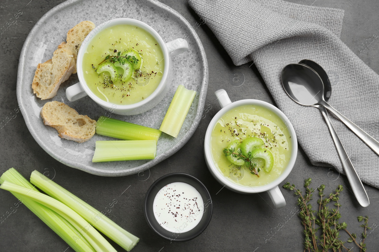 Photo of Delicious celery soup served on gray table, flat lay