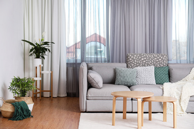 Photo of Windows with stylish curtains in living room interior