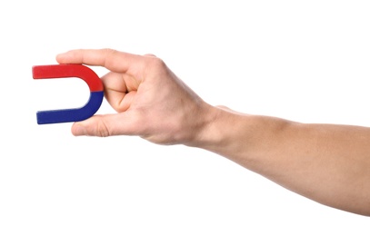 Man holding magnet on white background, closeup