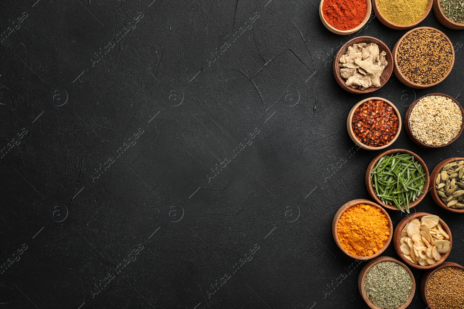 Photo of Flat lay composition with different aromatic spices on dark background