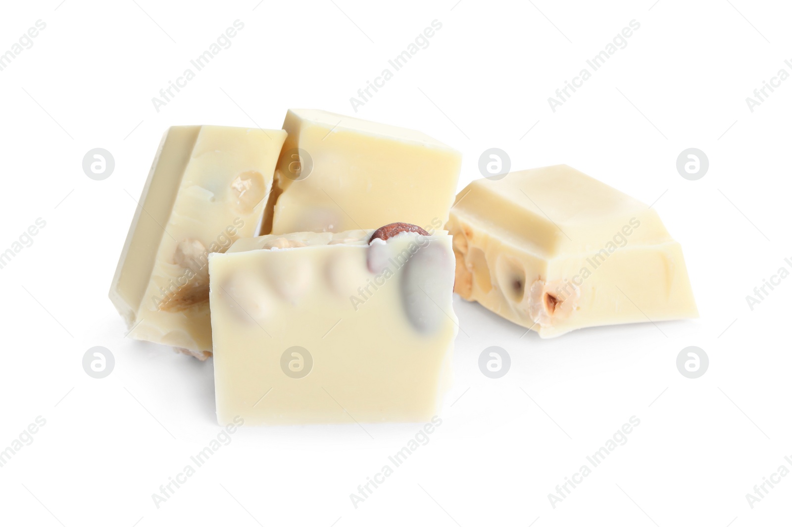 Photo of Pieces of tasty chocolate with nuts isolated on white