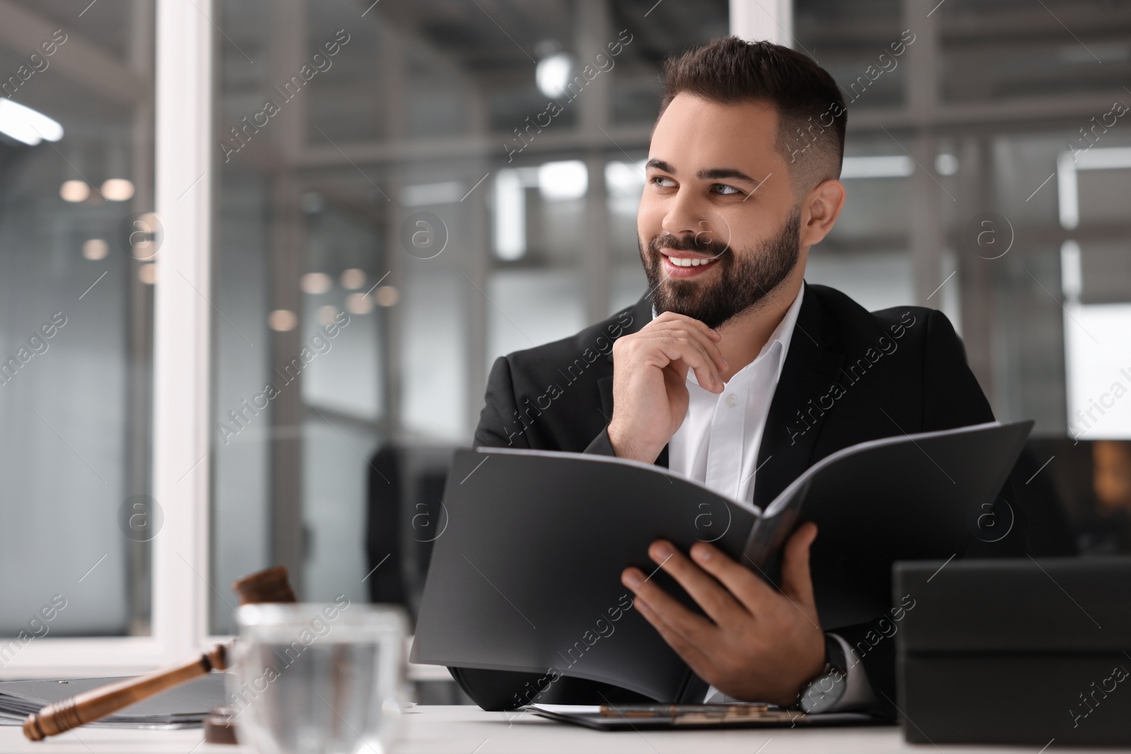 Photo of Smiling lawyer with folder in office, space for text