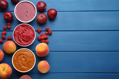 Different puree in bowls and fresh fruits on blue wooden table, flat lay. Space for text