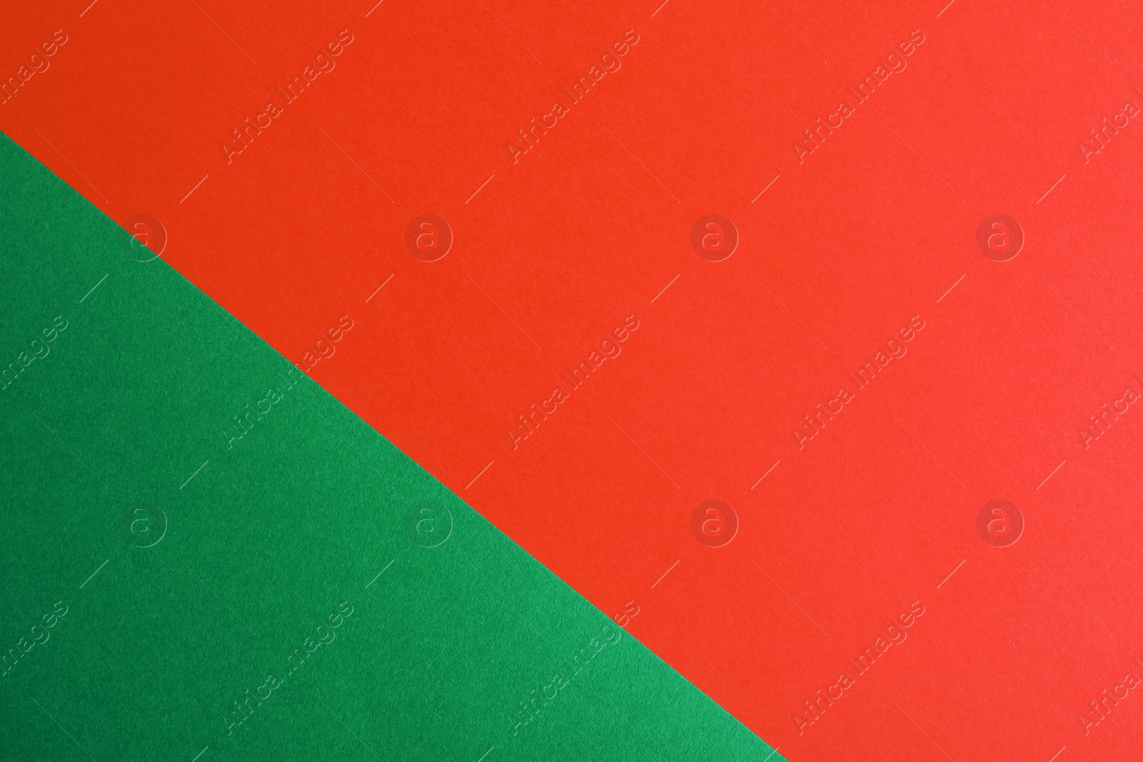 Photo of Green and red paper sheets as colorful background, top view