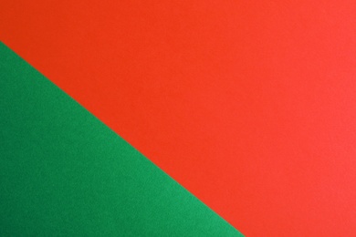 Photo of Green and red paper sheets as colorful background, top view