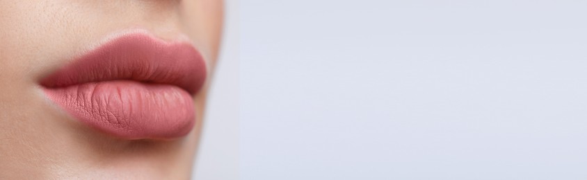 Image of Woman with beautiful lips on light background, closeup view with space for text. Banner design