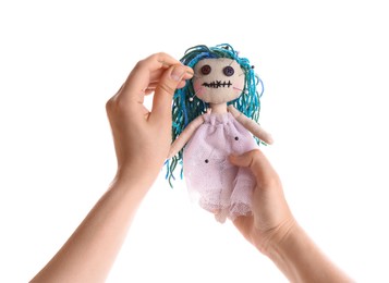 Photo of Woman stabbing voodoo doll with pin on white background, closeup. Curse ceremony