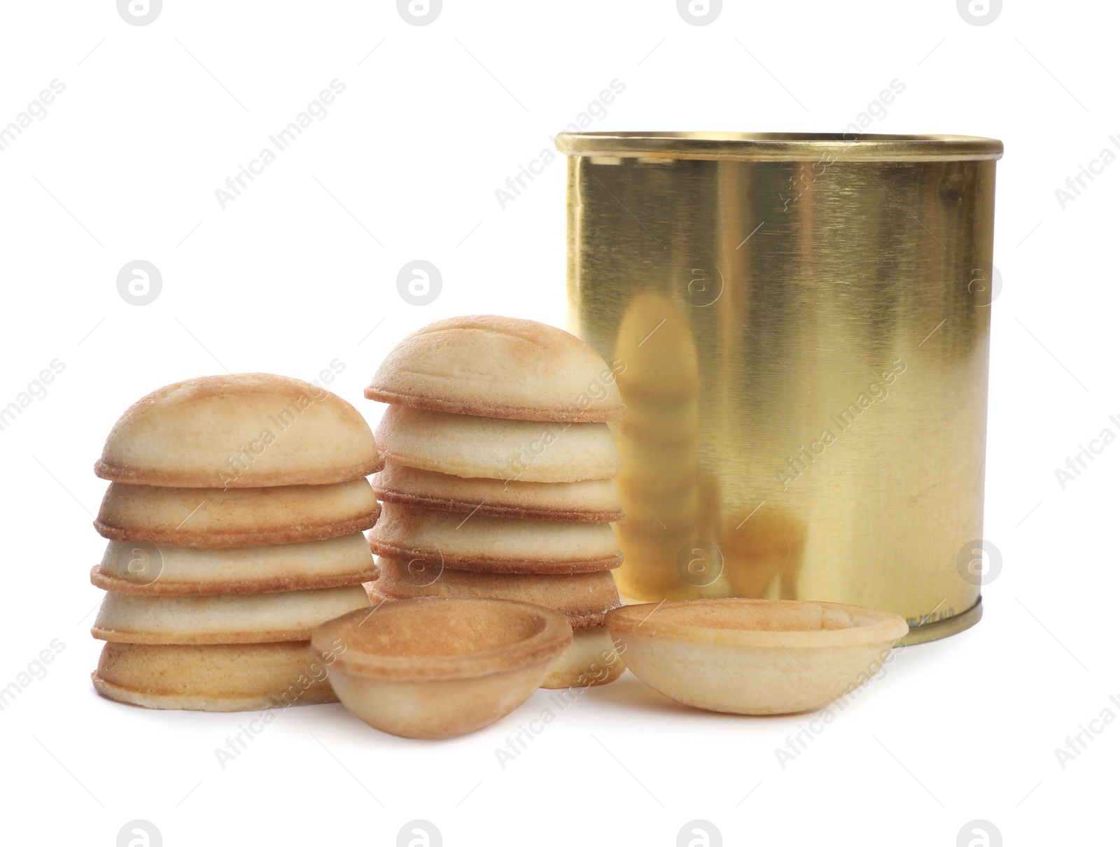 Photo of Making walnut shaped cookies. Cooked dough and boiled condensed milk in tin can on white background