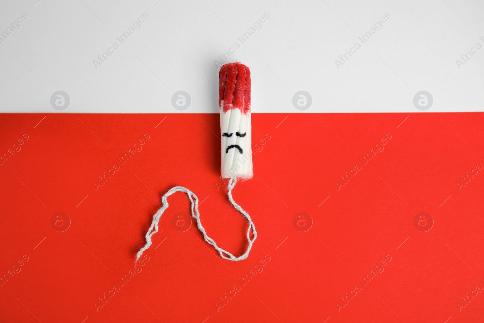 Photo of Used tampon on color background, top view