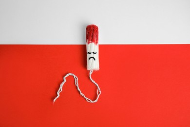 Photo of Used tampon on color background, top view