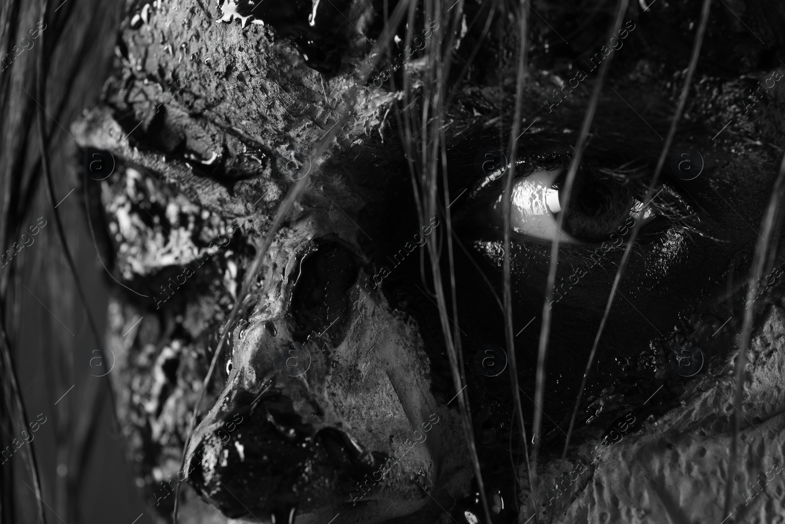 Photo of Closeup view of scary zombie, black and white effect. Halloween monster