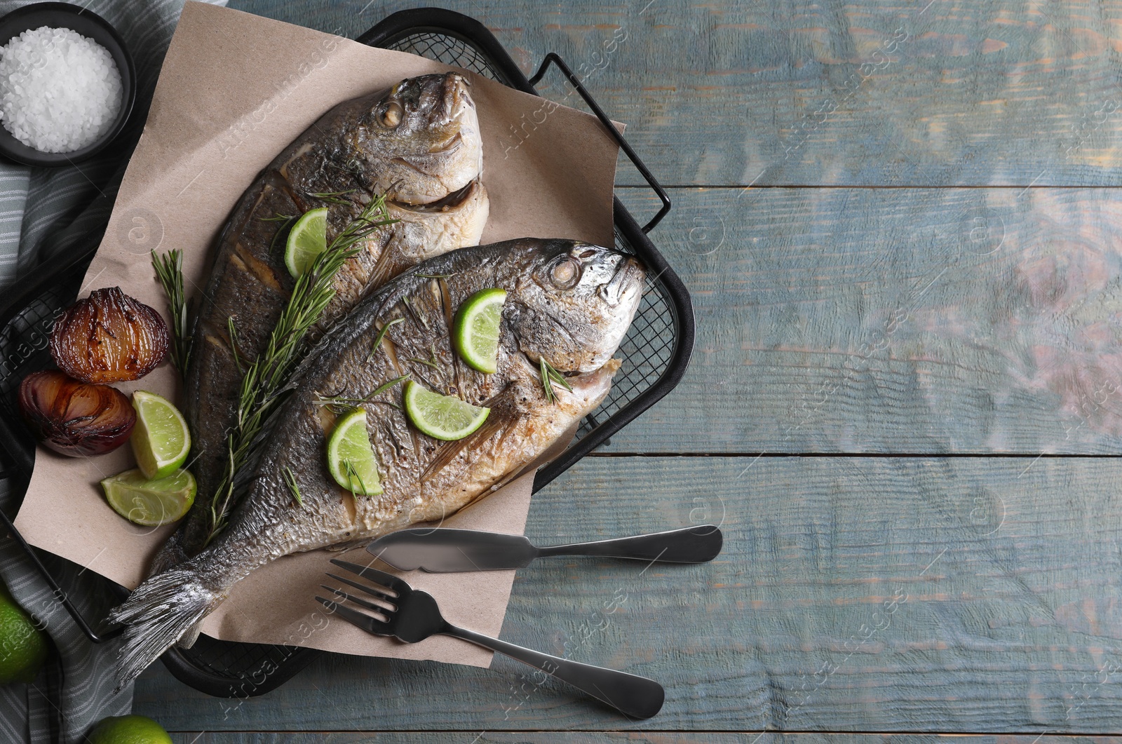 Photo of Delicious baked fish served on wooden rustic table, flat lay with space for text. Seafood