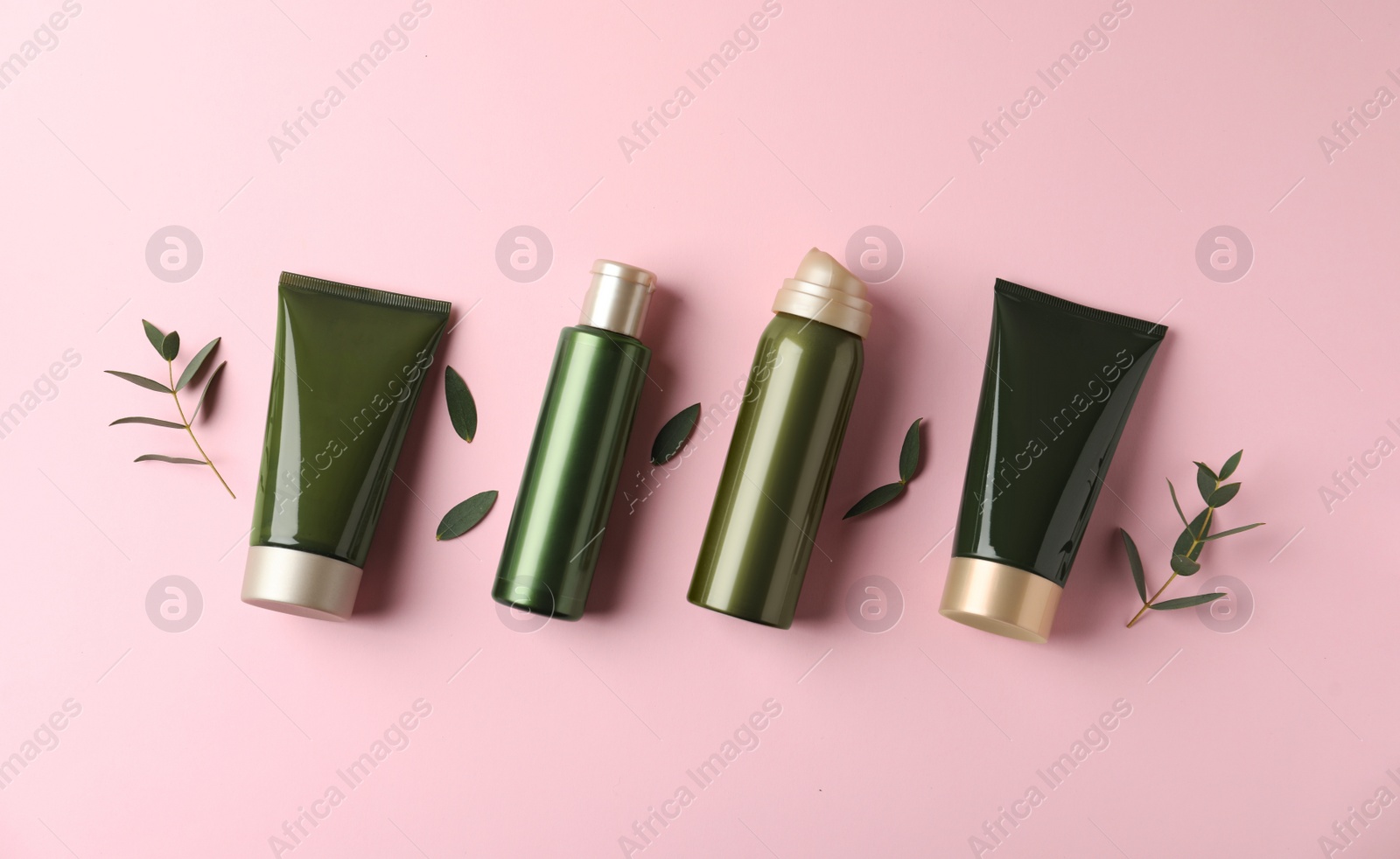 Photo of Flat lay composition with cosmetic products and leaves on pink background