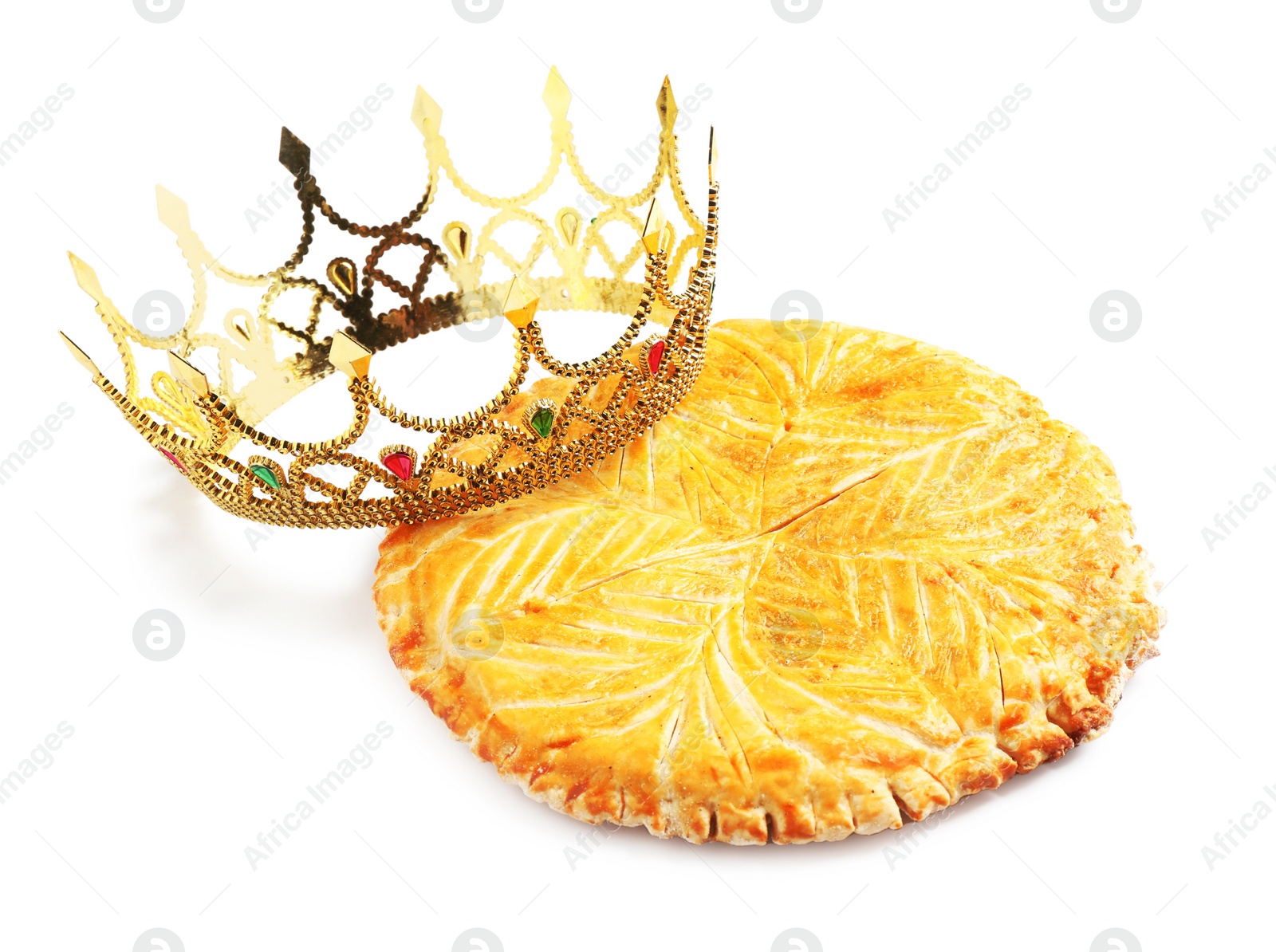 Photo of Traditional galette des rois and decorative crown on white background