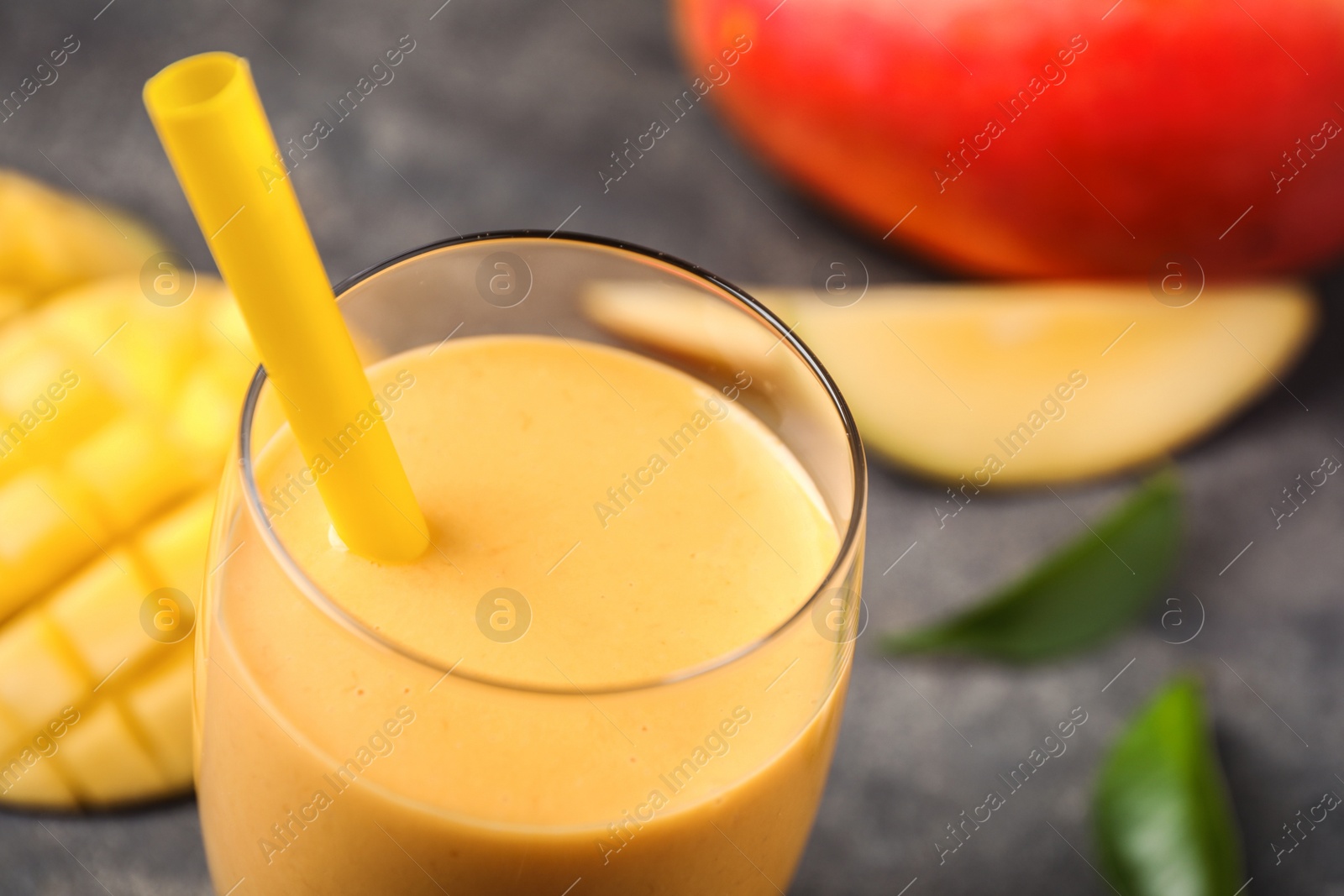 Photo of Fresh delicious mango drink on table, closeup