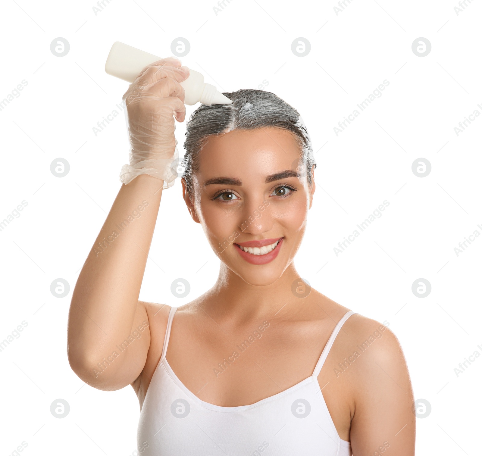 Photo of Young woman dyeing her hair against white background