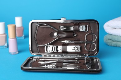 Photo of Manicure set in case on light blue background
