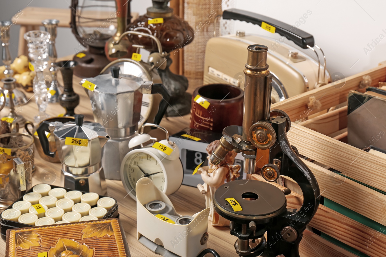 Photo of Many different items on wooden table. Garage sale