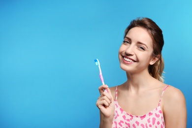 Photo of Portrait of young woman with toothbrush on color background. Space for text