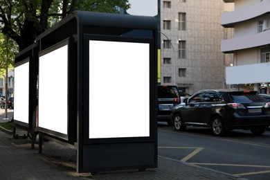 Bus stop with empty signboards in city. Mock-up for design