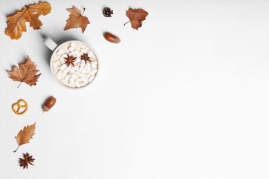 Flat lay composition with hot cozy drink and autumn leaves on white background. Space for text