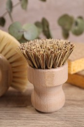 Photo of Small cleaning brush on wooden table, closeup