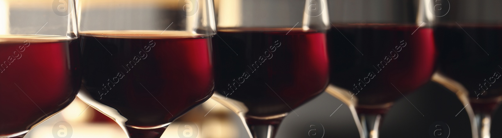 Image of Glasses with tasty red wine, closeup view. Banner design