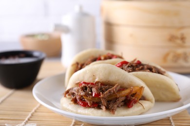 Photo of Plate with delicious gua bao (pork belly buns) on table, closeup