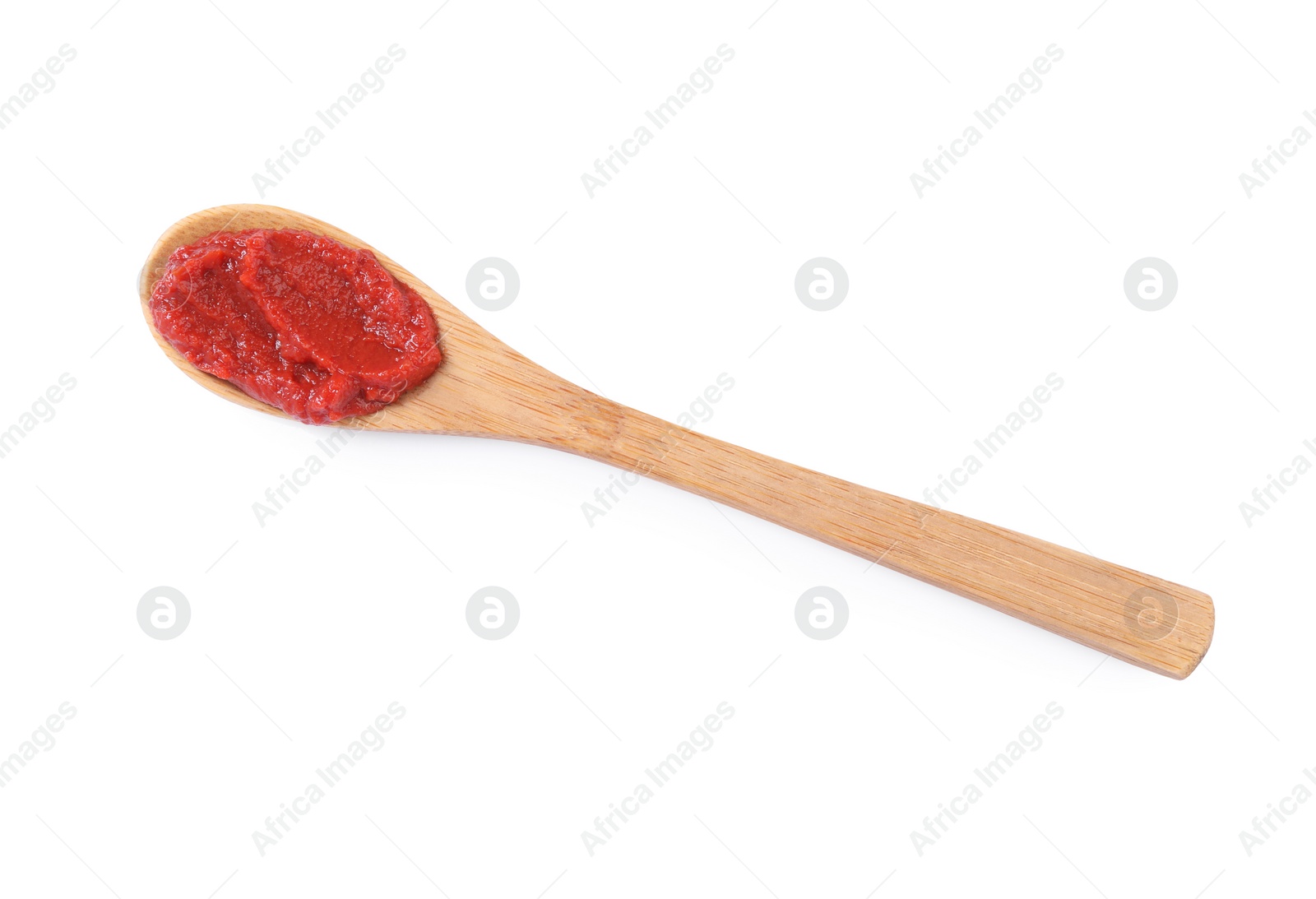 Photo of Wooden spoon of tasty tomato paste isolated on white, top view