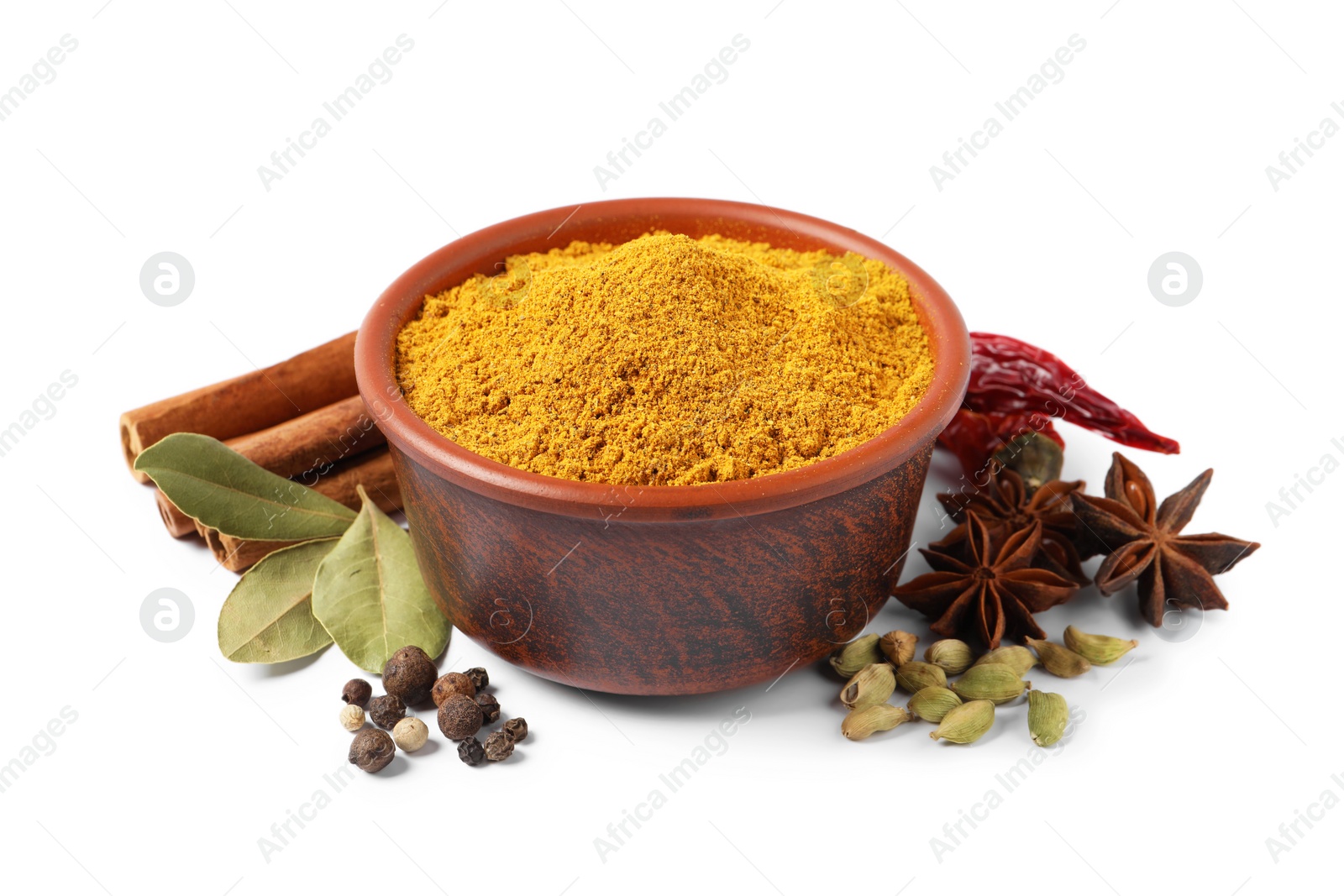 Photo of Curry powder in bowl and other spices isolated on white