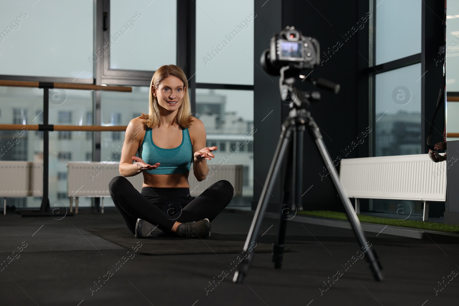 Photo of Fitness trainer recording online classes in gym