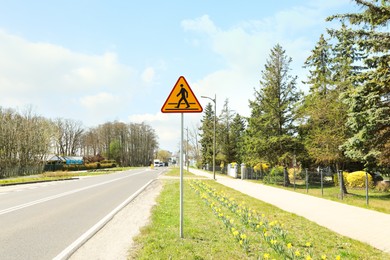 Traffic sign Pedestrian Crossing Ahead near road