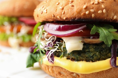Photo of Tasty vegetarian burger with spinach cutlet, closeup