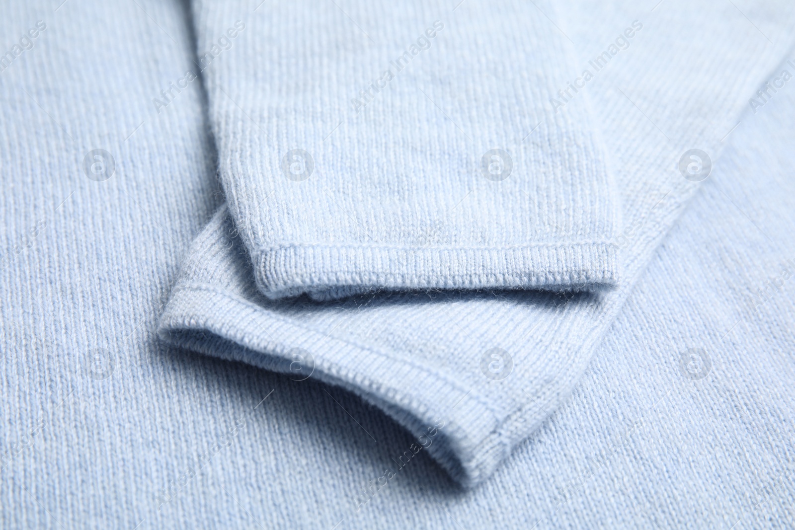 Photo of Warm cashmere sweater as background, closeup view