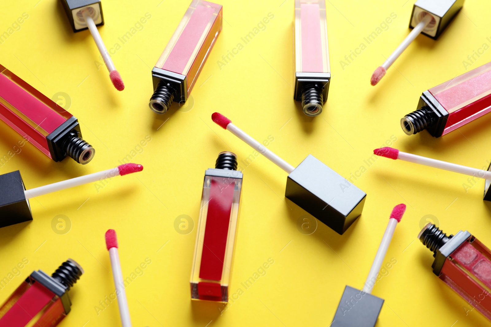 Photo of Composition of liquid lipsticks on color background