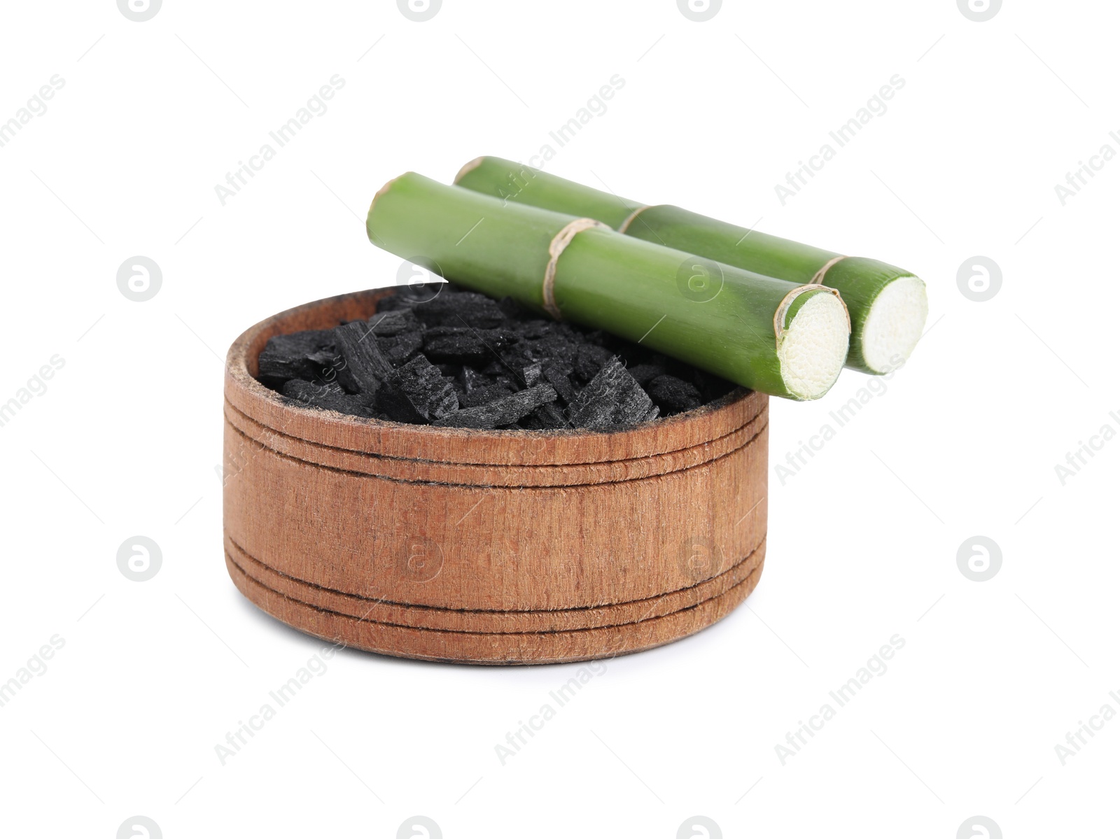 Photo of Fresh bamboo and charcoal on white background