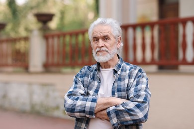 Portrait of happy grandpa with grey hair outdoors