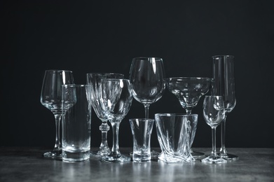 Set of bar glassware on table against dark background