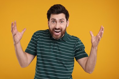 Photo of Portrait of surprised man on yellow background