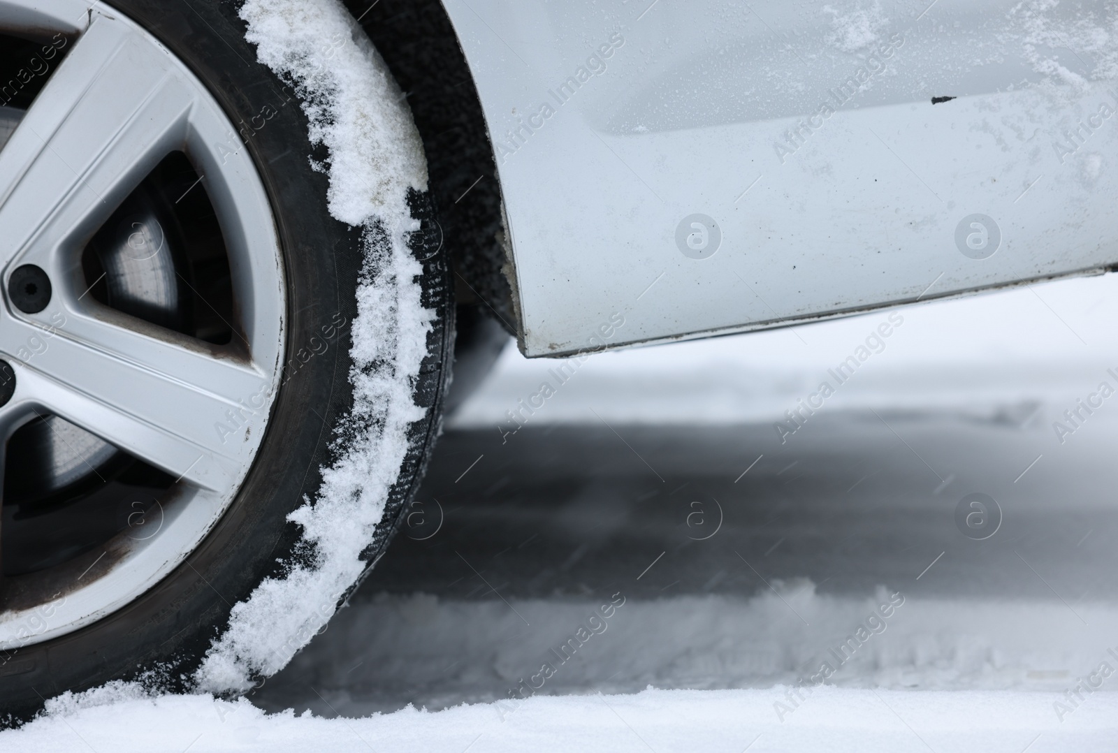 Photo of Car with winter tires on snowy road, closeup