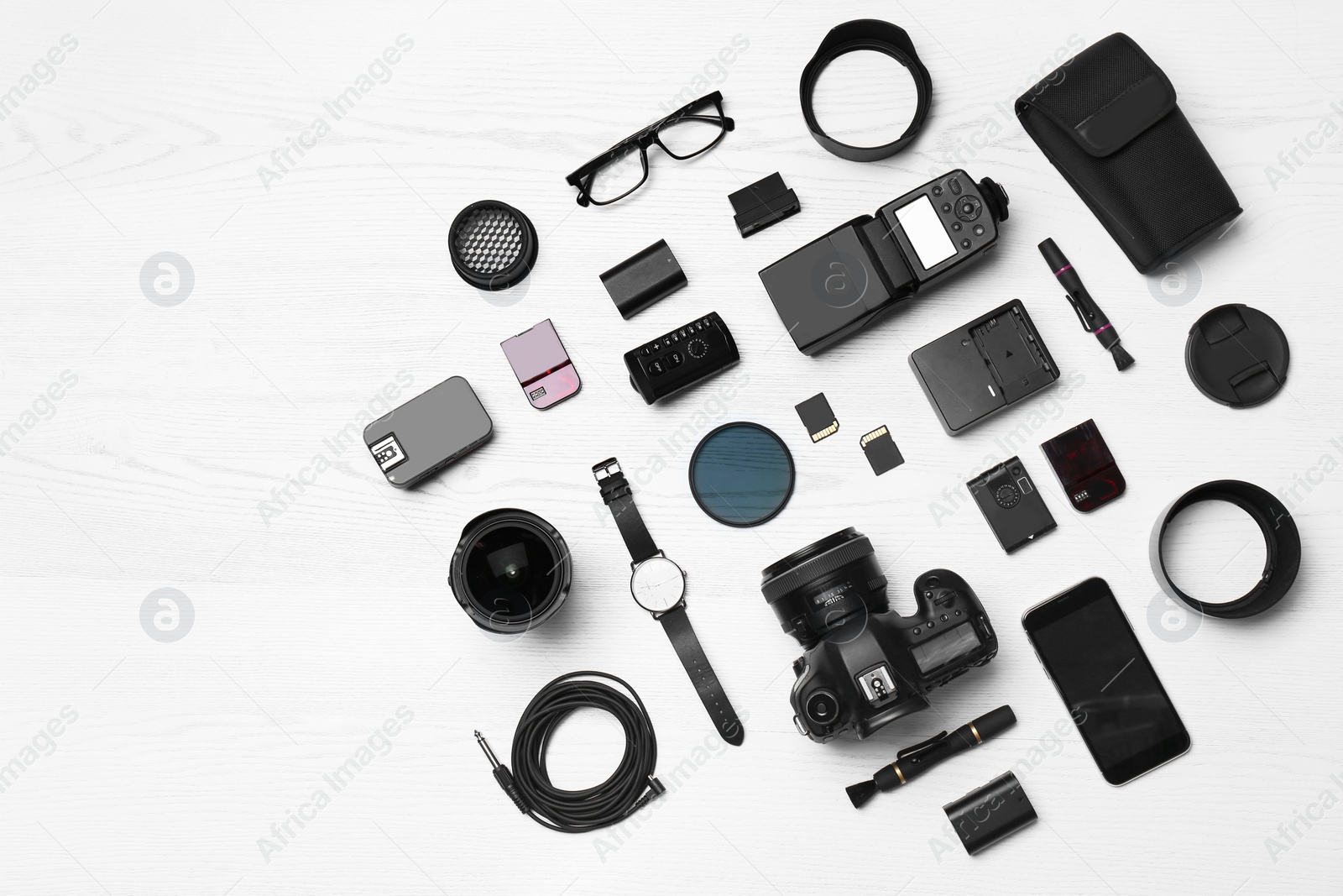 Photo of Flat lay composition with equipment for professional photographer on wooden background. Space for text