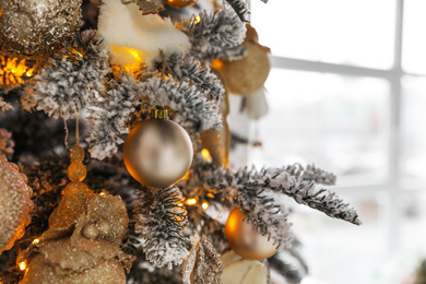 Photo of Beautiful Christmas tree Indoors, closeup. Festive interior decoration