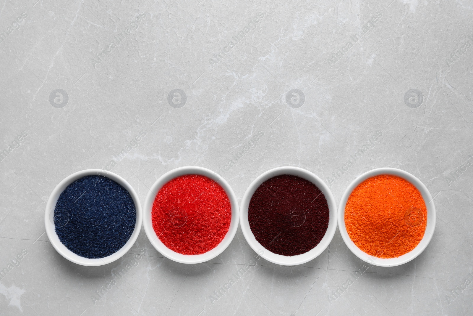 Photo of Many different food coloring on light grey marble table, flat lay. Space for text