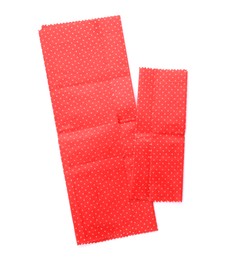 Red reusable beeswax food wraps on white background, top view