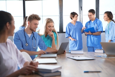 Photo of Group of smart medical students with gadgets in college