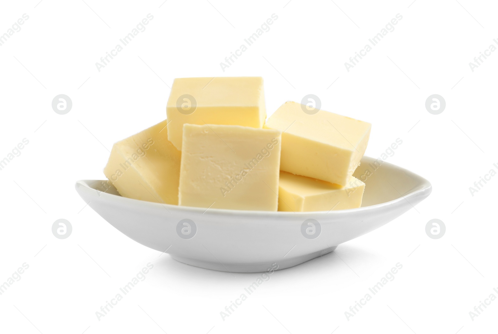 Photo of Ceramic dish with cut butter on white background