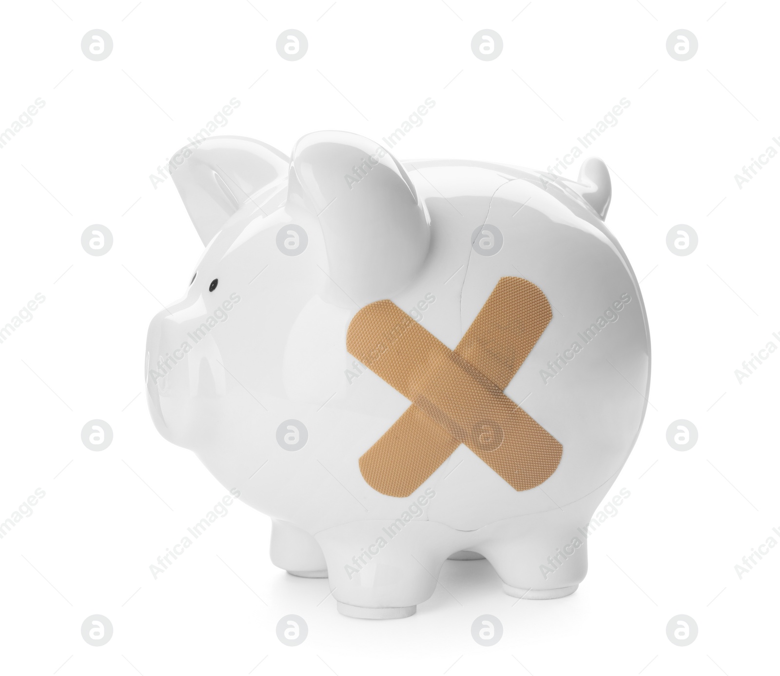 Photo of Piggy bank with sticking plasters isolated on white