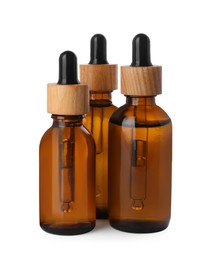 Photo of Bottles of essential oil on white background