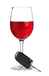 Glass of alcohol and car key on white background. Drunk driving concept